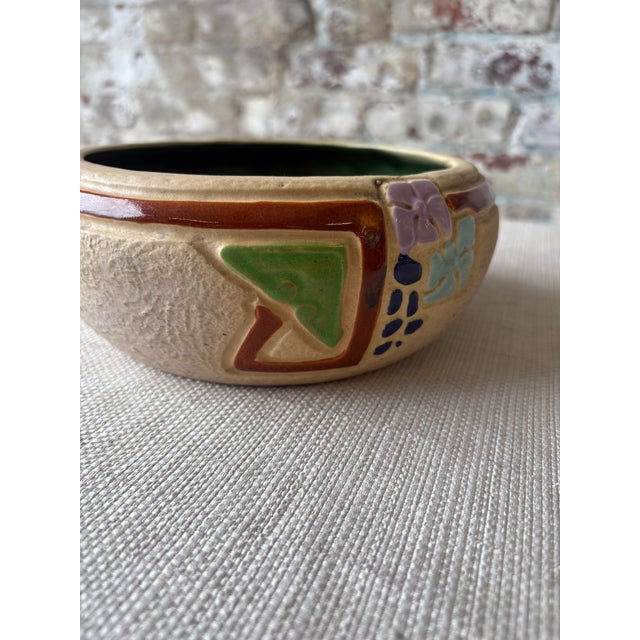 Striking vintage art pottery bowl featuring an embossed foliate motif with rich textural relief and hand-applied color...