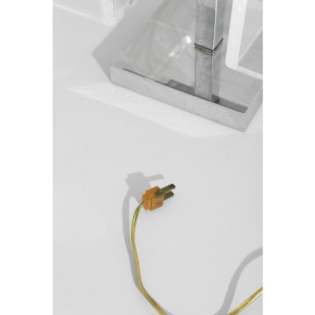 Cubist table lamp with dual clear lucite box shades set on a chrome base. A graphic, modern piece that plays with light,...