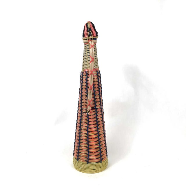 This colorful Mid Century decanter is wrapped and woven with bright pink, yellow, blue, and black. The lid fits well and...