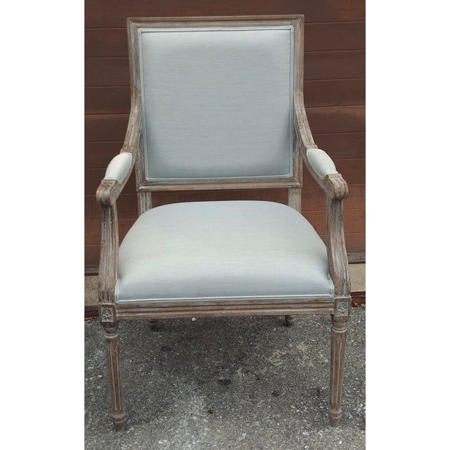 A French-style Louis XVI armchair , Upholstered with thick Aqua Linen and Carved Rustic Gray Oak Wood. Upholstery in...