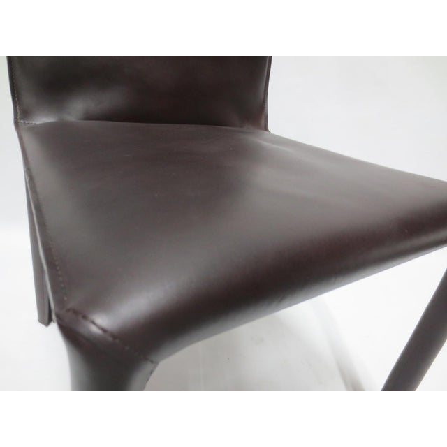 The Walter Knoll Saddle Chair 1243 N/A Saddle, Coffee 1, designed by EOOS, is a meticulously crafted piece that combines...