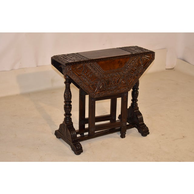 Early 18th century hand-carved oak gate leg table. This extraordinary piece is a one of a kind work of art. The artistry...