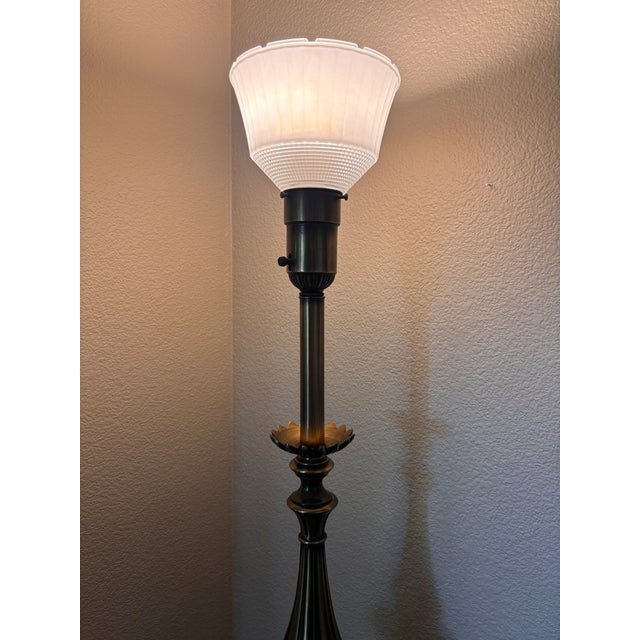 A striking vintage torchiere lamp by Rembrandt Lamp Company featuring richly detailed neoclassical styling and an elegant...
