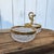 This vintage crystal and gold ormolu serving dish features double diamond-cut bowls, framed with intricate gilt detailing....