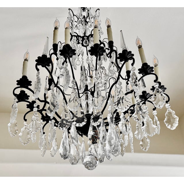 A large bronze and crystal chandelier. The Louis XV Birdcage holds fifteen lights in an elegant round form. French from...