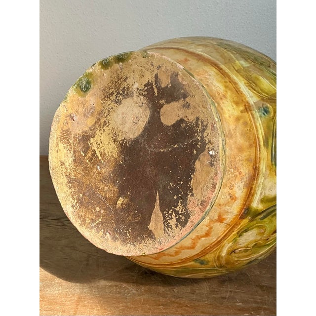 Invoke the rustic charm of a European countryside cottage with this enchanting vintage ceramic pitcher. Crafted in the...