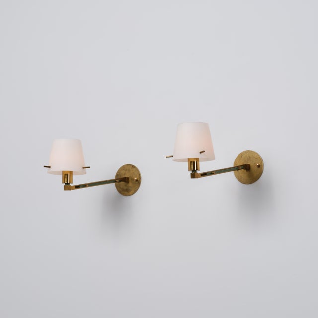 Pair of italian wall sconces dating from the 1950s, characterized by a refined mid-century composition combining brass,...