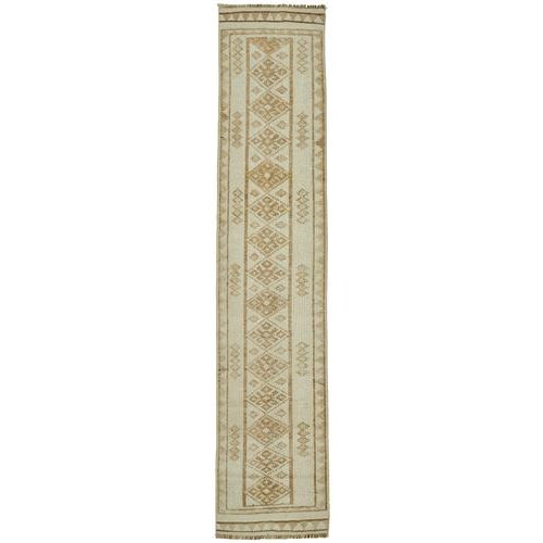 This exquisite runner rug is a rare example of tribal craftsmanship, hand-knotted by the women of the Herki tribe during...