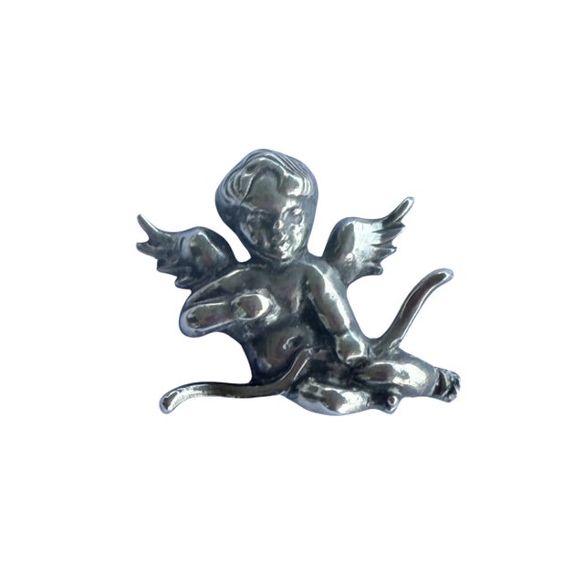 A fine vintage silver brooch in the form of a winged cupid with a bow. The piece has no marks but tests silver. Condition...