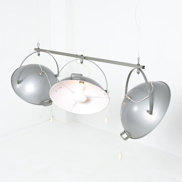 This amazing ceiling studio lamp was produced by Narita in Belgium in the 1950s. The grey lacquered shades are fixed on a...