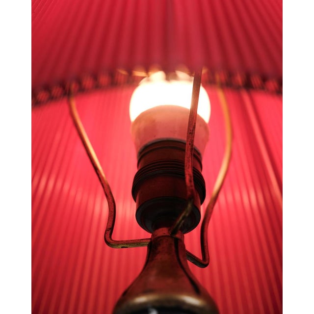 Table lamp made in gilded wood with carved details from around the 1940s. The lamp features a brass support and original...