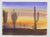 Late 20th century watercolor on paper painting of desert and cactus at sunset. Unsigned. Unframed.