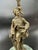 An elegant Louis XVI Revival figural bronze candelabrum featuring a standing gentleman dressed in 18th-century attire,...