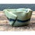 This pottery bowl reads as a piece of frozen movement, its undulating rim rippling outward in soft, irregular waves that...