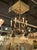 The product is an early 20th-century Italian gilt tole and crystal chandelier. It features a beautifully crafted design...