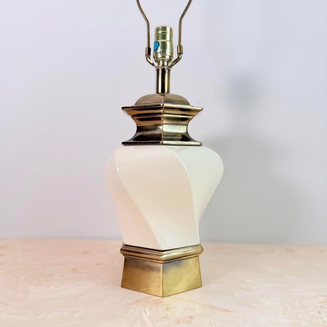 A substantial Stiffel table lamp with a faceted cream ceramic body in an octagonal urn shape, capped top and bottom in...