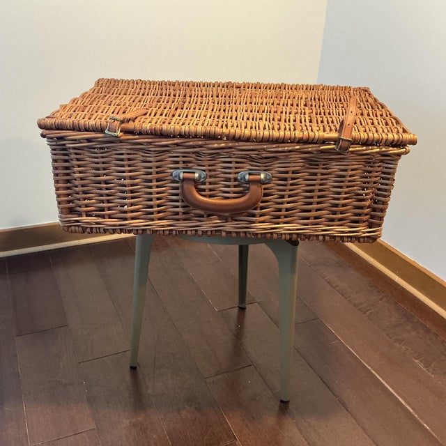 Charming vintage Blinton England wicker picnic hamper featuring a complete service for four. The interior lid neatly...
