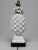 A decorative white glazed ceramic table lamp modeled in pineapple form, with a deeply textured body composed of raised...