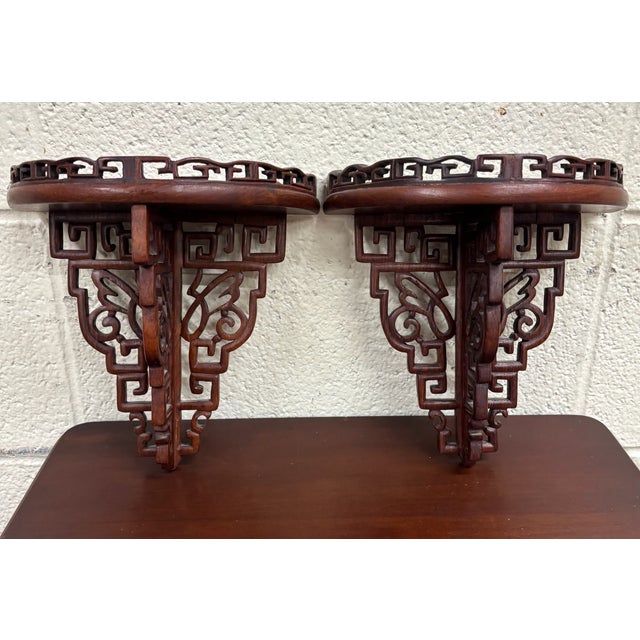 This is a beautiful pair of vintage Chinese Chippendale wall brackets or shelves featuring intricate pierced fretwork,...