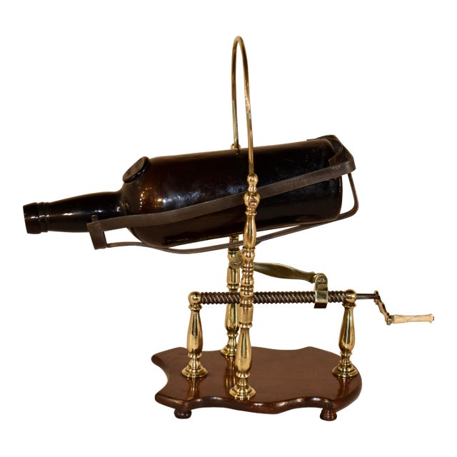 A very handsome English port or wine decanter made from bell metal, steel and iron, supported on a mahogany base in the...