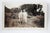 Circa 1920's sepia snapshot photograph of a couple dressed up to go on an adventure. Unframed, scattered minor crazing.
