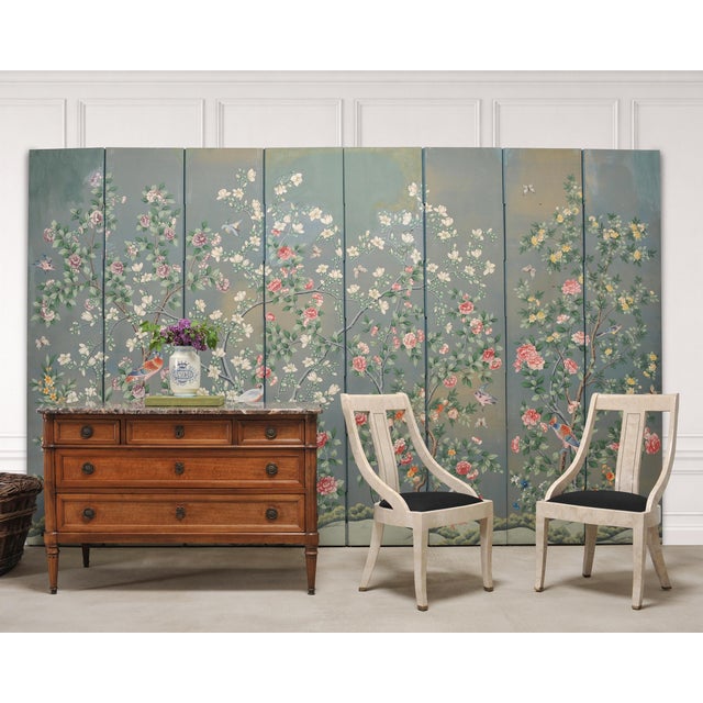 A monumental and decorative eight-panel Chinoiserie folding wallpaper screen attributed to Gracie. The grand screen...