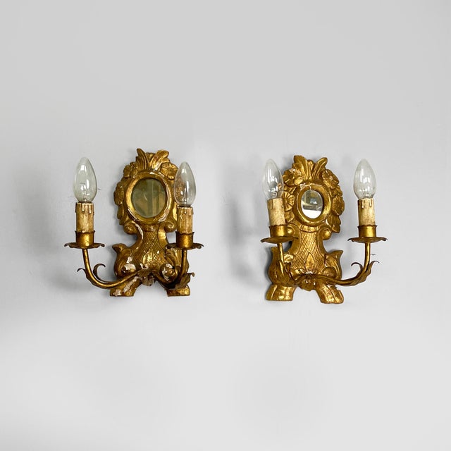 Italian two light wall lamps with mirror and in wood with gold finish, 1700s Pair of wall lamps in wood with gold finish....