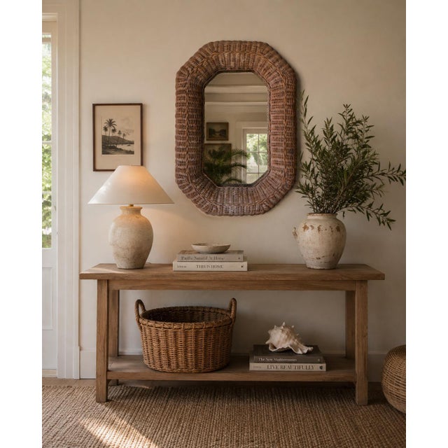 Beautiful 1980s vintage wall mirror featuring a substantial handwoven wicker frame with a softly sculptural octagonal form...