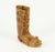 An intricate finely carved wooden figurine It features an tall boot with laces, rendered with great detail A small mouse...