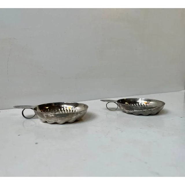 A decorative pair of sommelier tasting cups from Chateau de Meursault in France. They are made from ornamented silver...