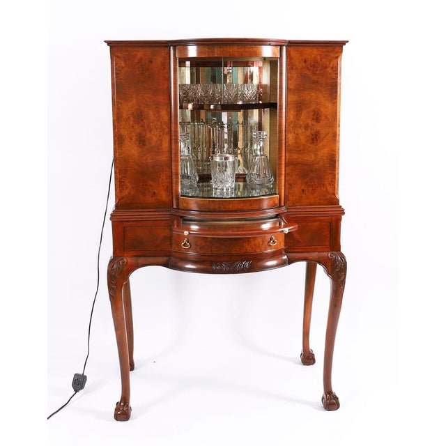 This is a fantastic antique Queen Anne Revival burr walnut cocktail cabinet with a fitted and mirrored revolving interior,...
