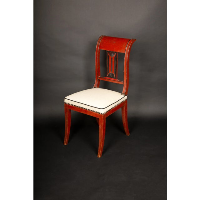 This remarkable salon suite from the Directoire period (circa late 18th century) includes a finely crafted small sofa...