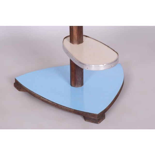 This Mid-Century flower stand from the mid-20th century was crafted in Czechoslovakia. Made from beech wood, Formica, and...