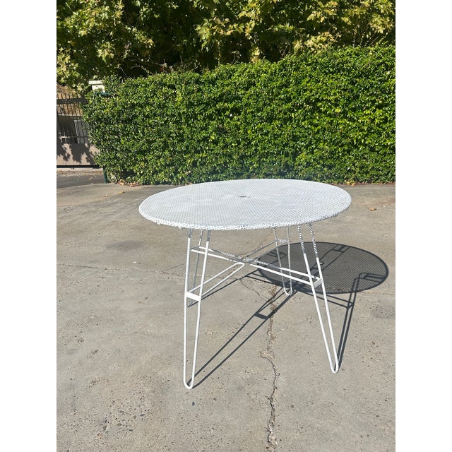 Round garden table attributed to Mathieu Matégot, a key figure in 1950s French design. Made of white lacquered tubular...
