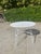 Round garden table attributed to Mathieu Matégot, a key figure in 1950s French design. Made of white lacquered tubular...