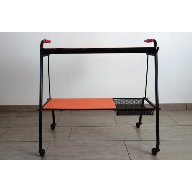 Vintage rolling serving cart in perforated metal and painted Formica, circa 1950. Very slight signs of wear on the base....