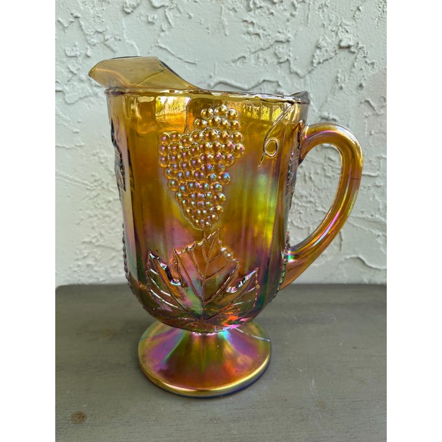 Bring a warm touch of vintage Americana to your table with this stunning 9-piece Marigold Carnival Glass lemonade set by...