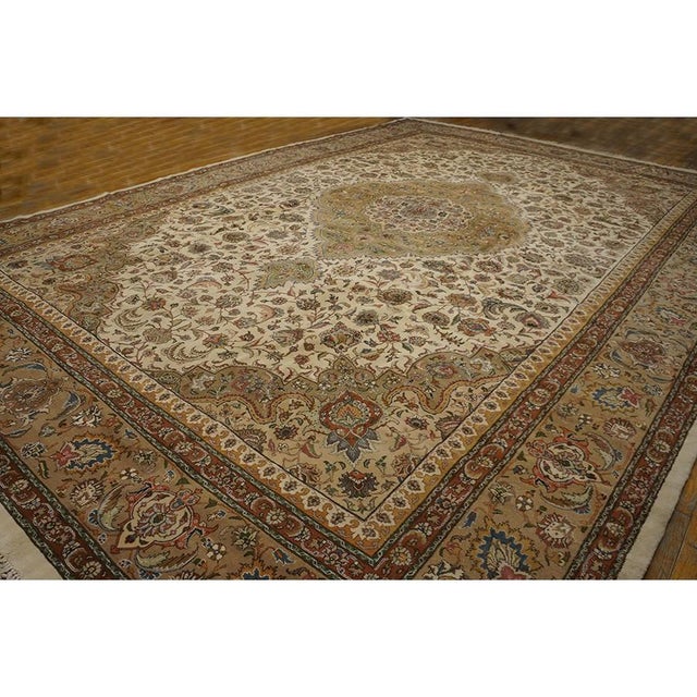 This is a grand Antique Tabriz rug from Iran, dating to approximately 1940. It is a classic example of Formal design,...