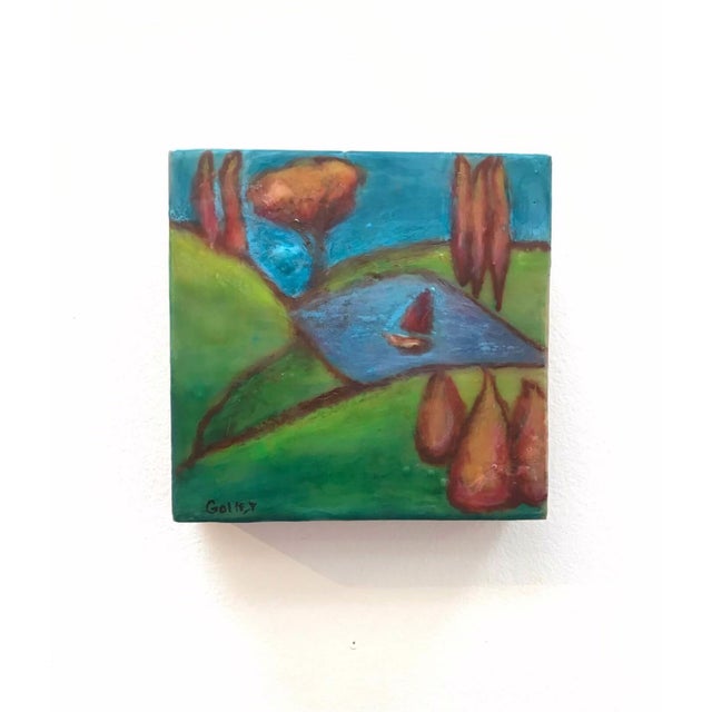 This encaustic work on wood panel presents a serene landscape, featuring rolling hills, a tranquil blue pond, and a small...