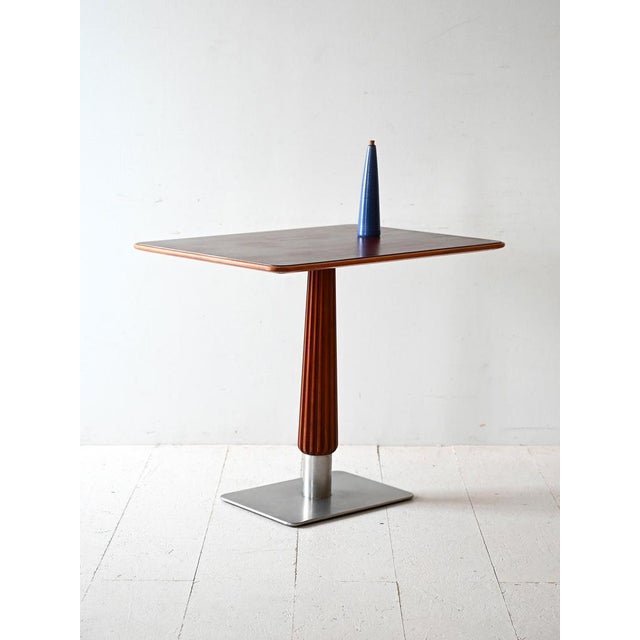 Scandinavian 1930s coffee table with mahogany top, carved stem and square base in brushed steel. Compact elegance and deco...