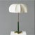 The shade is cream umbrella-shaped pleated fabric (full and soft texture, softens light), the lamp body features a dark...
