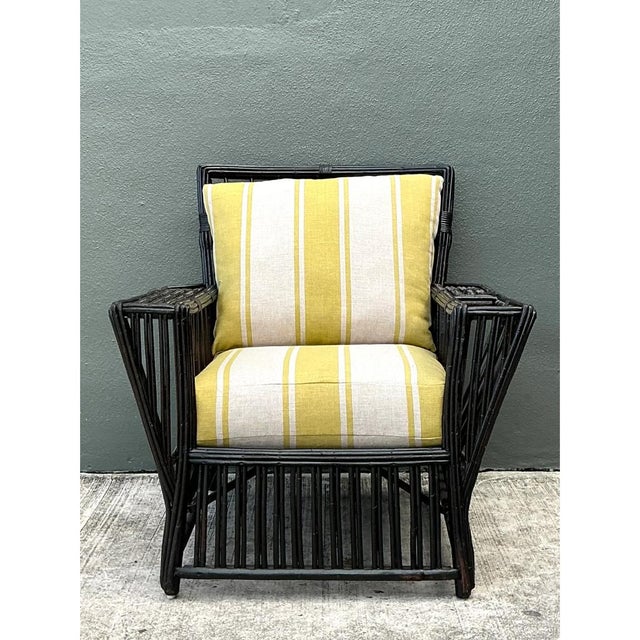 This vintage stick rattan lounge chair showcases classic early 20th-century tropical furniture design, its architectural...