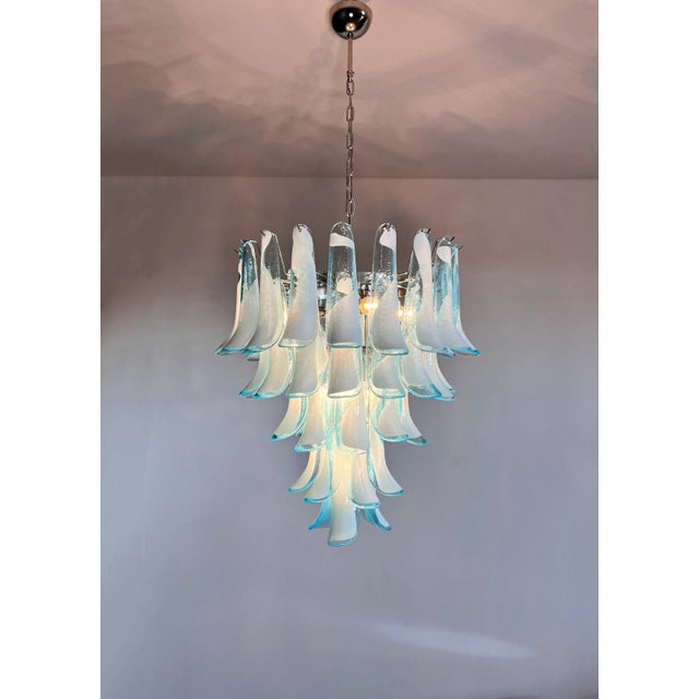 A stunning large Murano chandelier featuring 52 exquisite hand-blown glass petals in a striking combination of blue and...