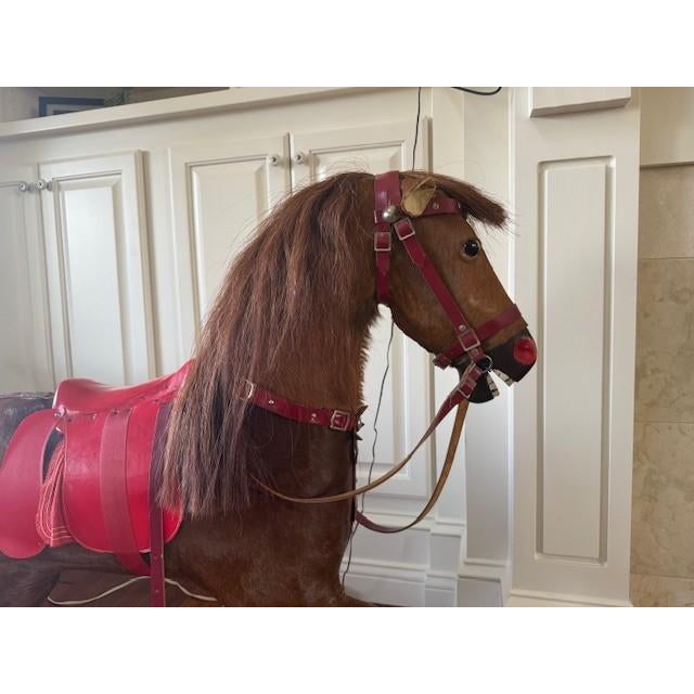 A striking and authentic vintage horsehide hobby horse, likely attributed to Nikolaus Klein of Chicago, dating to the...