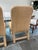 Unique pair of fully upholstered raffia side chairs. The chairs feature natural woven raffia upholstery with rich textural...