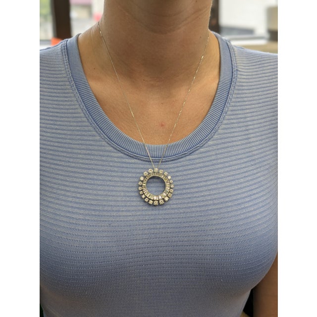 Timeless elegance meets modern simplicity. This circle pendant features sparkling earth-mined diamonds set in solid...