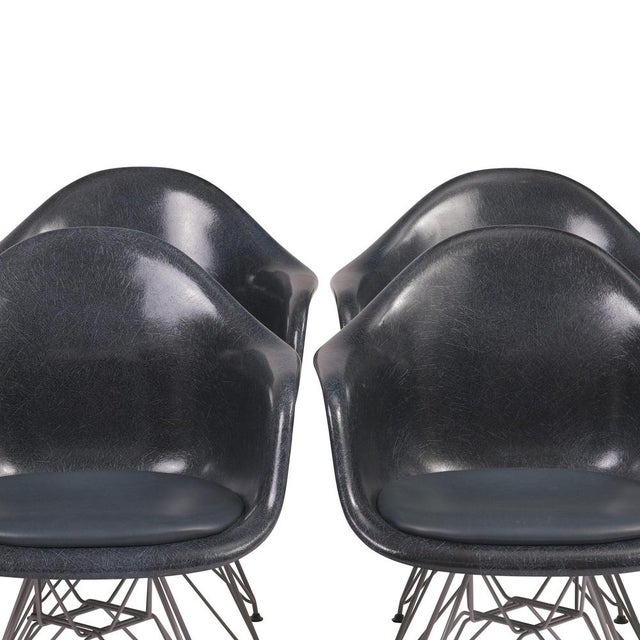 Set of Eames Armchairs, designed by Charles & Ray Eames, 1970s. Fiberglass seat shell in navy blue with seat cushion,...