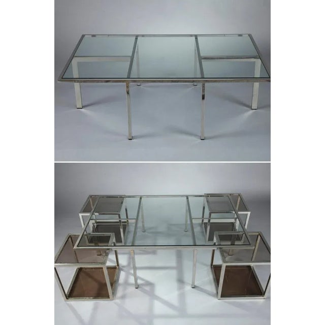 Coffee table in chromed metal and glass dating from the 1970s. The main glass and chromed metal table is rectangular and...
