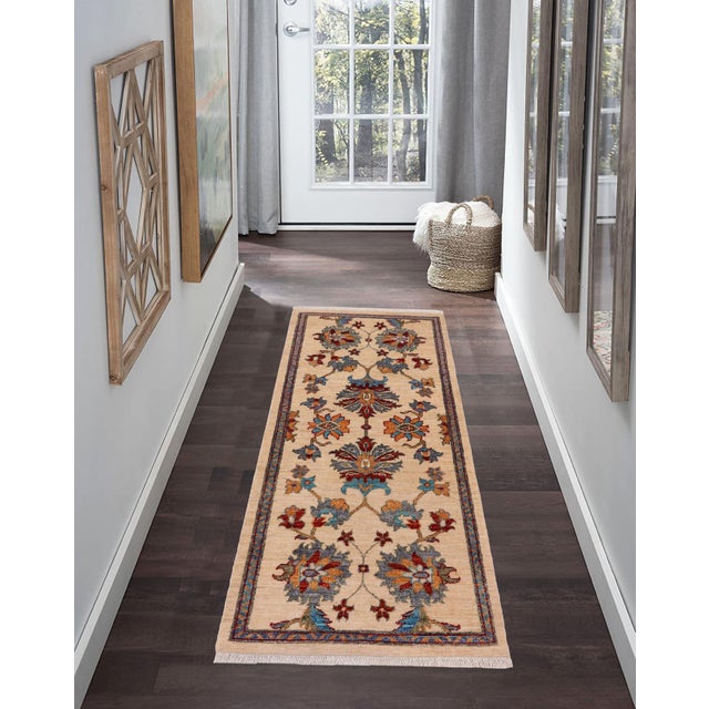 Enhance the ambiance of your home with this magnificent Persian-influenced Turkish hand-knotted rug made by skilled...