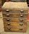 Industrial style workshop chest of drawers made of wood and steel bin pulls. It features five drawers, one with a divider....